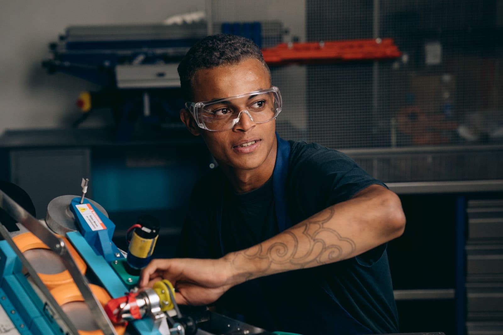 An engineer operating machinery on a factory floor